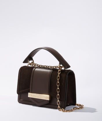 Brown handbag with gold chain on a light gray background